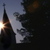 The spin of the earth impaled a silhouette of the sun on the steeple.