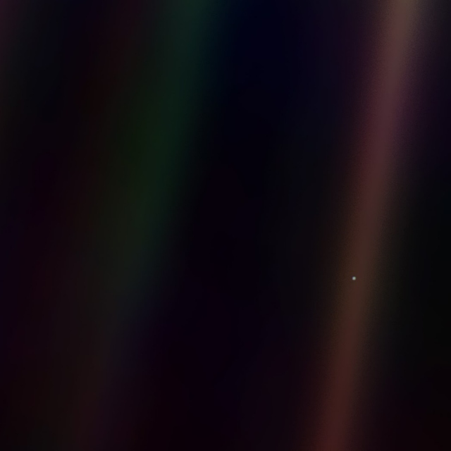 Pale blue dot on a mote of dust